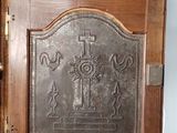 a wooden door with a metal plaque on it