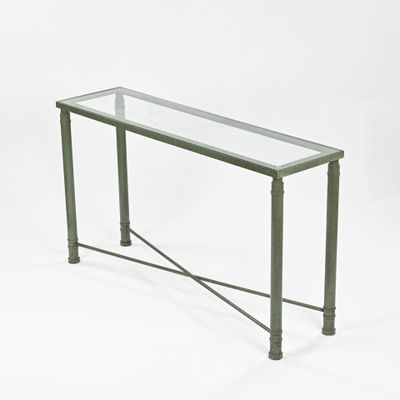 a glass table with metal legs and a glass top