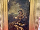 un tableau représentant une femme jouant de la guitare, dans un cadre doré