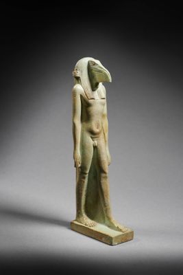 an egyptian statue of a man with a bird ' s head on his head