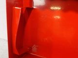 a red telephone that has a black button on it