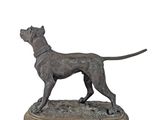 statue of a dog standing on a wooden base on a white background
