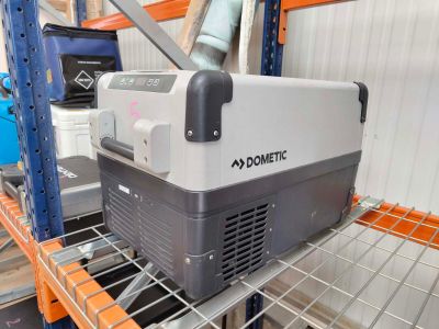 a cooler that is sitting on a shelf in a warehouse