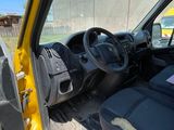 a yellow truck with a black seat in the back of it