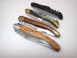 several different types of knives are lined up on a white surface