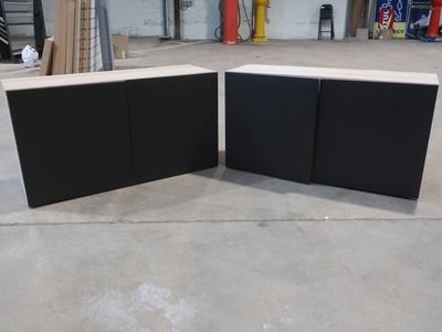 two pieces of black and white furniture in a warehouse