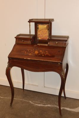 a small desk with a clock on top of it