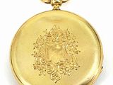an image of a gold pocket watch sitting on a white surface