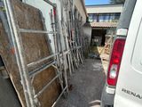 a van parked in front of a building with scaffolding around it