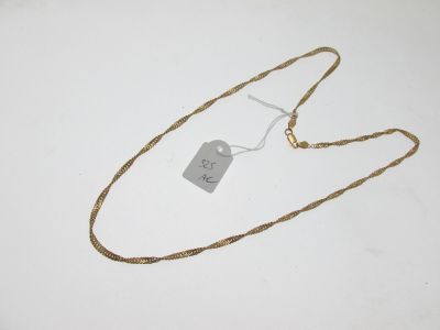 an image of a necklace with a tag on it on a white surface