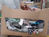 a cardboard box full of clothes on a pallet