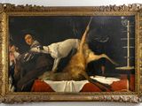 un tableau représentant un homme avec un chien sur un lit