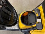 a close up of a yellow forklift with the door open