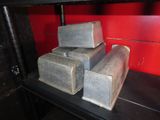 three silver bars stacked on top of each other on a shelf
