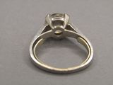 a close up of a diamond ring on a table