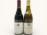 two bottles of wine sitting next to each other on a white surface