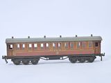 a red and brown train car on a white surface