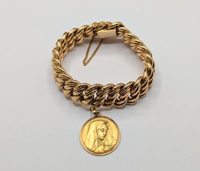 an image of a gold bracelet with a coin on it