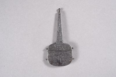 a small metal object that is on a white surface
