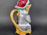 a small vase that has a bird on top of it
