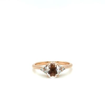 a close up of a ring with a brown and white diamond
