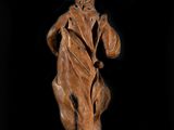 an old statue of a man with a hat and a robe