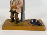 a figurine of a man standing next to a street light