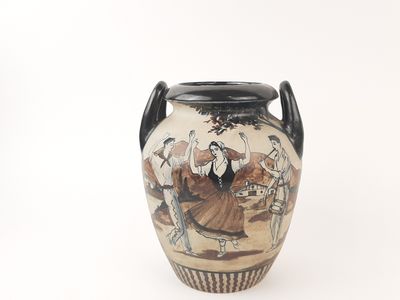 a vase with a painting on it sitting on a table