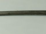 a close up of a sword on a white surface