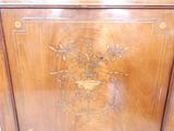 a wooden cabinet with a decorative design on it
