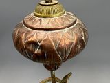 a bronze statue of a bird and a bird on a pedestal