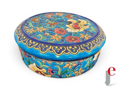 a blue box with flowers on it on a white surface