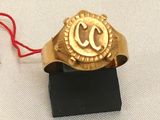 a gold ring with a red string around it