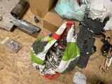 a pile of assorted items on the floor next to a box