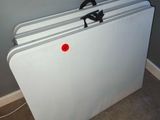 a white refrigerator with a red button on it