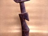 statue of a person with a hat on his head and a feather on his head