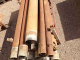 a pile of pipes sitting on the ground next to each other