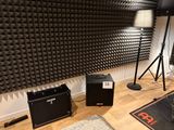 a room with speakers, speakers, and speakers on the floor