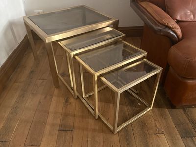 three tables that are sitting on a wooden floor