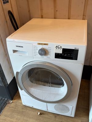 a washer and dryer sitting next to each other in a room
