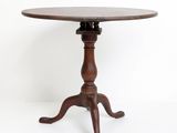 an old wooden table with a wooden top and a wooden base