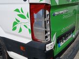 a white van with a green leaf on the back of it