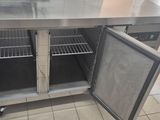a stainless steel kitchen island with two doors open