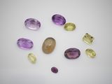 a group of different colored stones on a white surface
