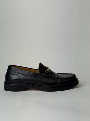 a close up of a pair of black loafers on a white background