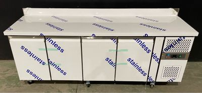 a group of four freezers sitting on top of a counter