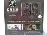 a box with two speakers in it and a man on the phone
