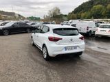 a white car parked in a parking lot next to other cars