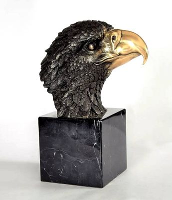 statue of an eagle head on a marble block on a white background