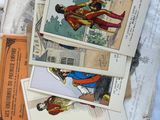 a pile of old postcards with pictures of superheros on them